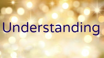 Red Christmas gift box and baubles on background of defocused golden lights.